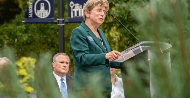 President Drugovich speaking at a podium