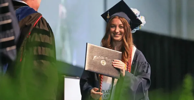 Female student receiving her diploma