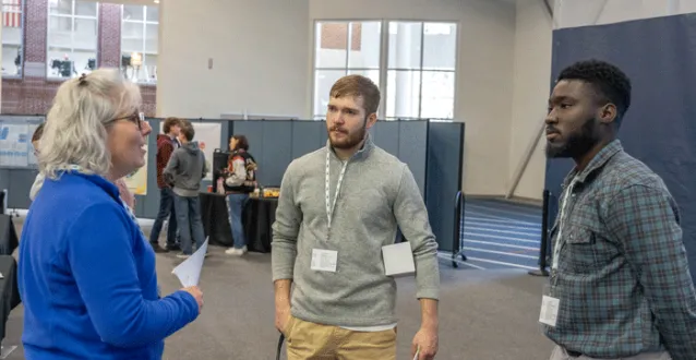 Students speak with an energy industry employee