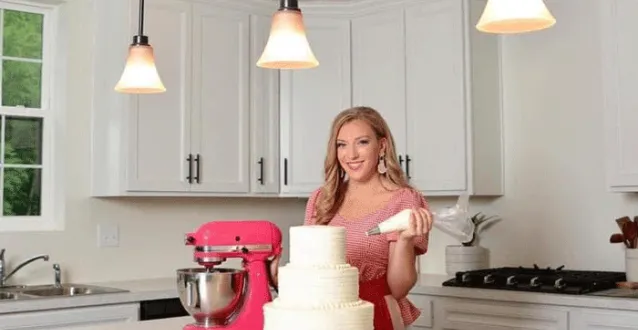 Bre Herrick in the kitchen with a cake