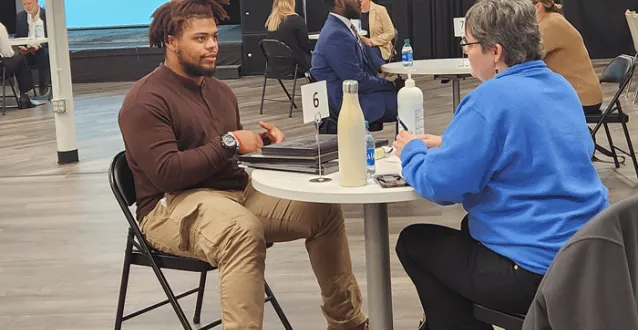 Male student speaking with an interviewer