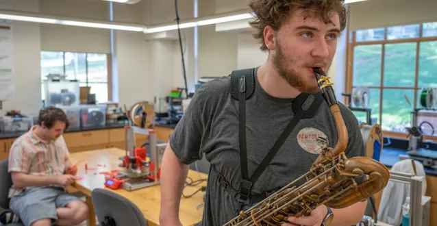 Kellen Franks ’27 plays a baritone saxophone as part of 2024 All Scholars Day