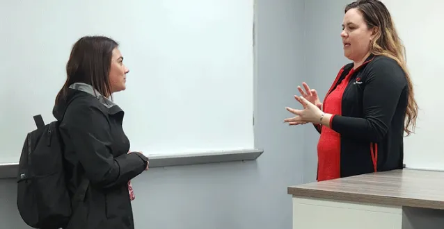 Student speaking with presenter