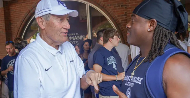Joe Chlapaty chats with a student.