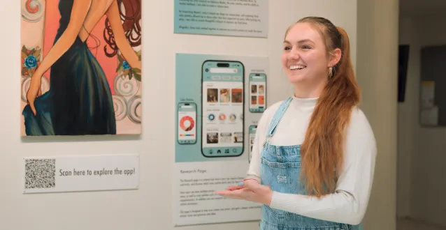 Female graphic design student presents art project