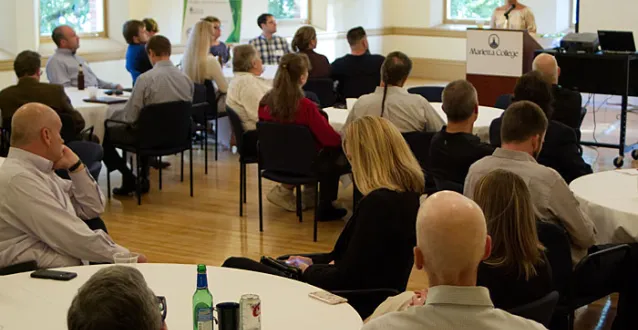 People listen to speaker at a conference
