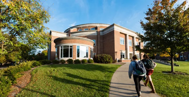 Two students walking toward Legacy Library