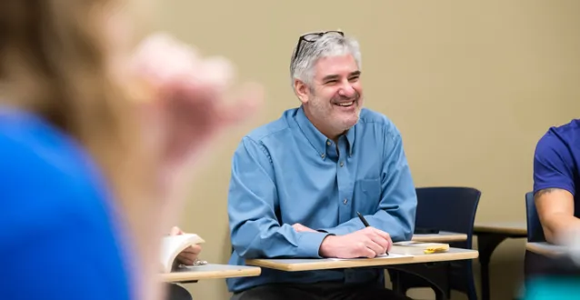 Professor Tim Catalano sitting in a classroom