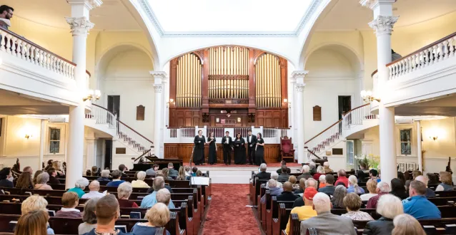 Wide shot from inside church during concert