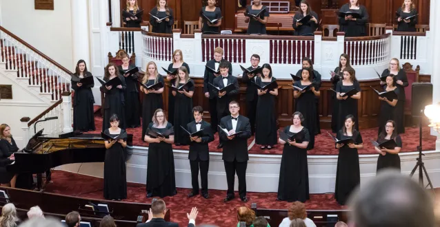 Choir members singing in a church