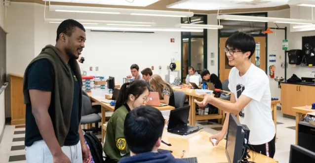 Students speaking while working on a class project