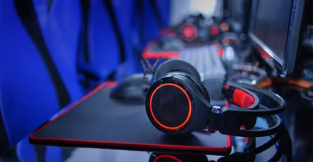 headphones laying next to a computer screen