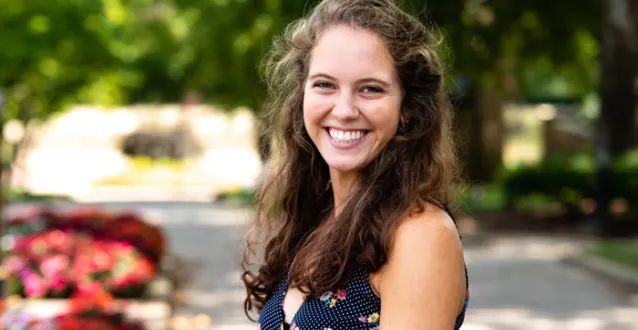 Rebecca Guhde smiling while standing on The Christy Mall