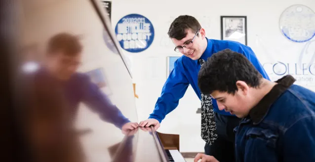 Students playing a piano