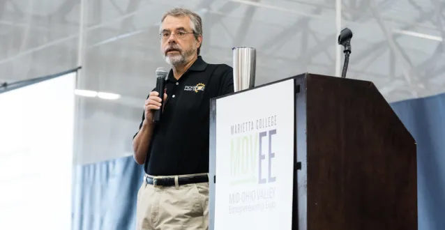 Man standing next to a podium in the DBRC