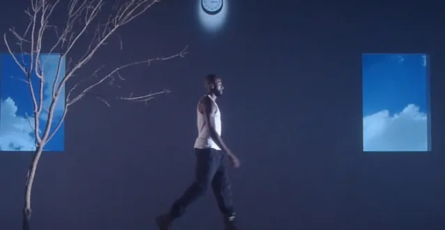 Man standing on a treadmill with images behind him