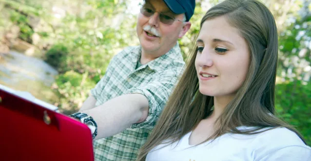 Dave McShaffrey working with a student in the field