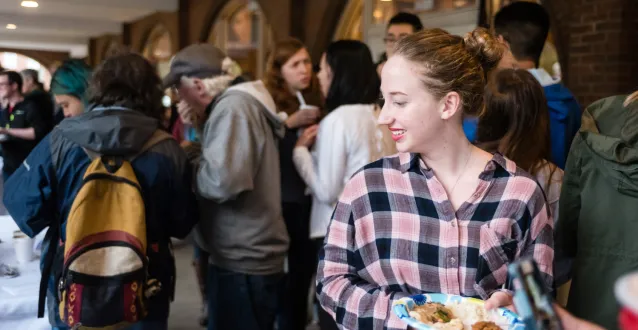 Female student carrying a plate of food during the Multicultural Festival