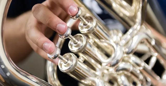 close up photo of hands on an instrument