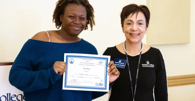 MHS' Kayla Floyd receives her certificate from Jackie Khorassani