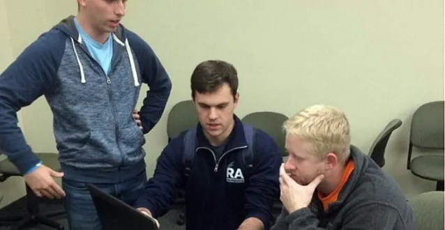 Marietta students working out a problem on a laptop computer