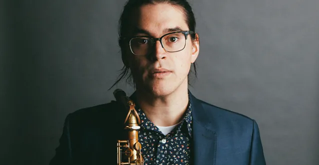 Jordan Reed holding a saxophone