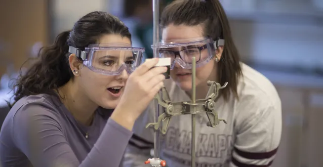 Two female students conducting a science experiment