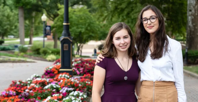 Two female students standing next to each other on The Christy Mall
