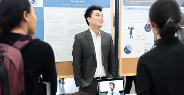 Male student making a presentation during All Scholars Day