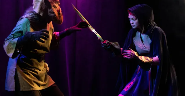 Actress fighting a monster in a play