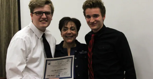 Two high school students with Jackie Khorassani at Junior PioBiz