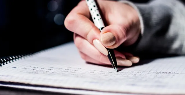 Person writing in a notebook
