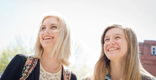 Two students smiling