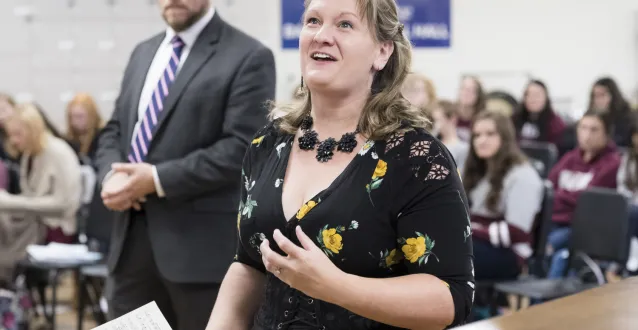 Amy Yekel singing to a class of students