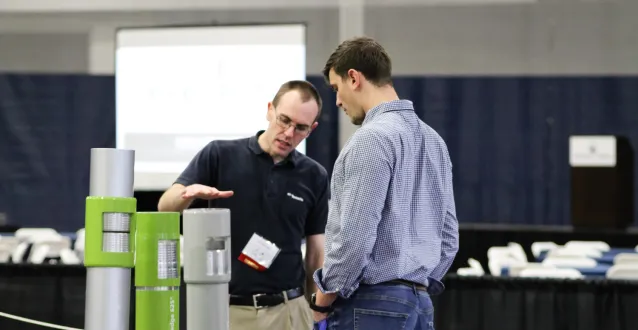 Worker explaining something to a student