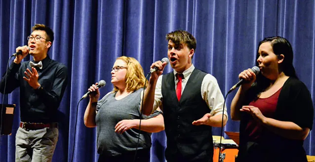 four students singing