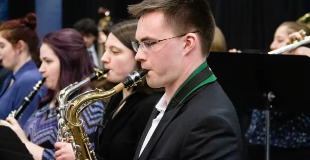 Male student playing the saxophone