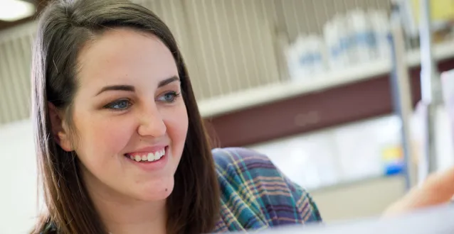 Art student pointing at her painting