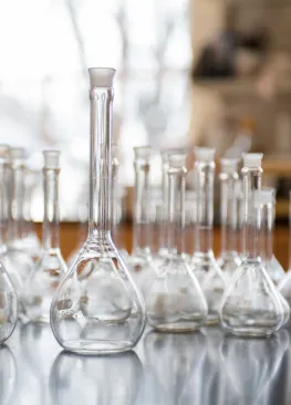 Displays beakers sitting on a table in a Biochemistry classroom.