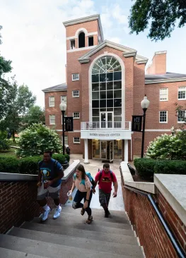 Students walking up the steps in front of Rickey Science Center