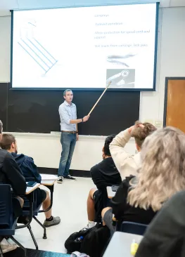 Professor Jeremy May points to a screen while teaching Marietta College Biology majors.