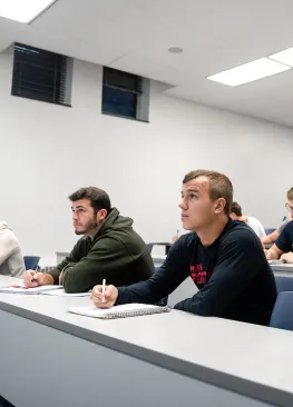 Economics majors take notes during an econ class.