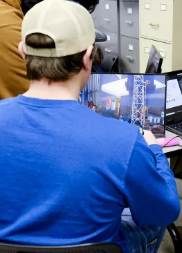 An Energy Systems Engineering minor interacts with a video during class