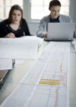 Students minoring in Energy Systems Engineering lay out a graph on a table