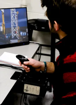 An Energy Systems Studies minor interacts with a drill simulator during class