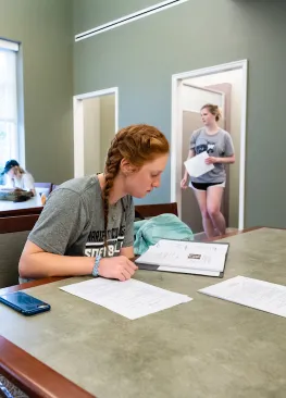 An english major studies in the Legacy Library at Marietta College