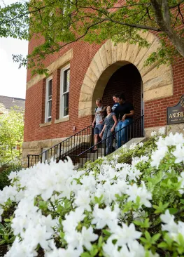 Students exit Andrews Hall and walk down the stairs towards The Christy Mall on the campus of Marietta College