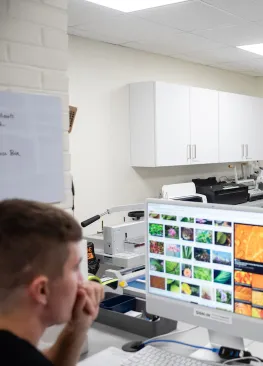 A Marietta College student majoring in graphic design works on a project at a computer in the Deem Design Center