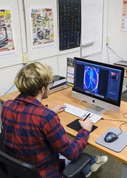 A Marietta College student majoring in graphic design works at a computer in a classroom