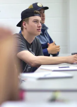 A Marietta College Mathematics major follows along during class.